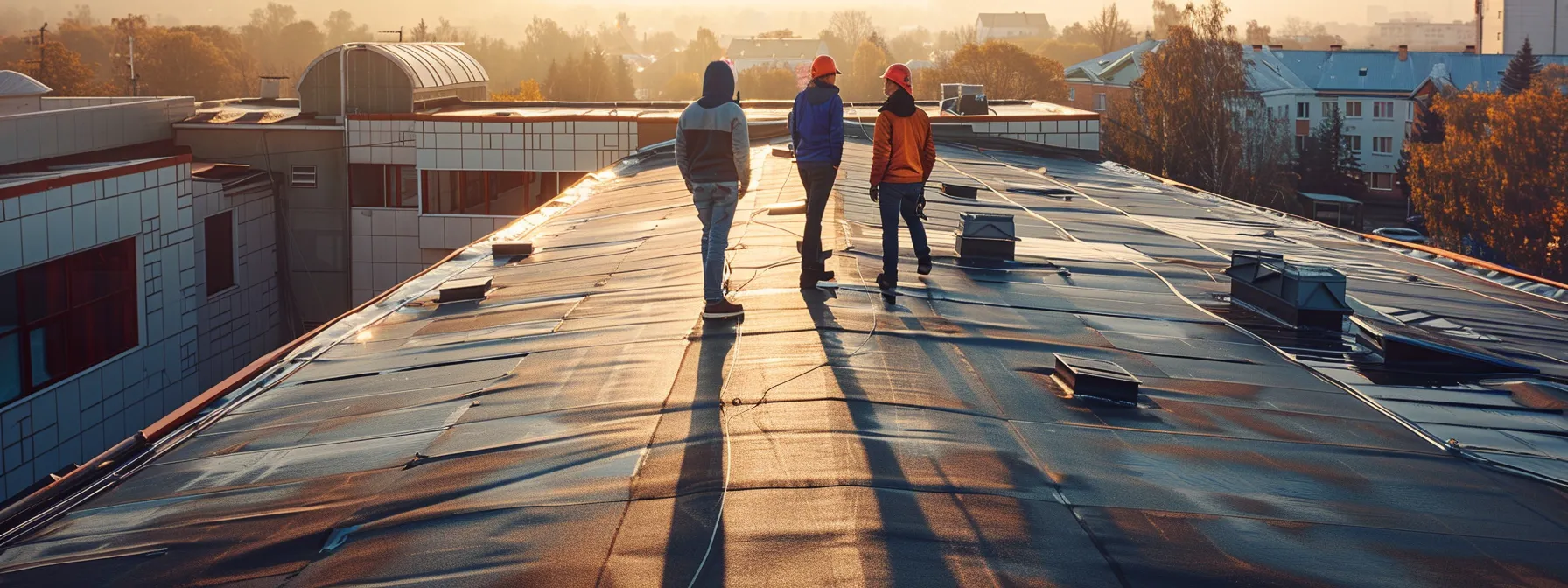 a team of roofers inspecting a commercial property for ventilation issues.